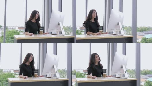 女商人在工作场所使用电脑。年轻的亚洲女商人思考和工作在电脑办公室高清在线视频素材下载