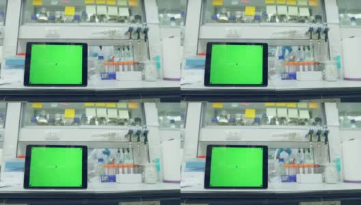 平板绿色屏幕背景与科学家在实验室工作高清在线视频素材下载
