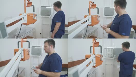 医院里的医生使用x光机工作。一位成年医生正在调整医疗设备。一个穿着专业医疗服的人，没有病人，前景是x光机高清在线视频素材下载