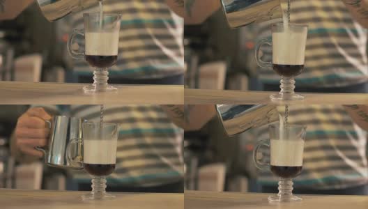 咖啡师将牛奶倒入咖啡玻璃杯中，准备拿铁咖啡高清在线视频素材下载