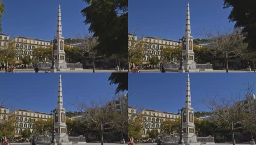 西班牙马拉加。大约在2018年3月。游客参观纪念托里霍斯将军的方尖碑在广场德拉默塞德，受欢迎的广场在历史中心。高清在线视频素材下载