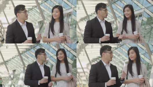 中国女商人和男商人在户外喝咖啡聊天高清在线视频素材下载