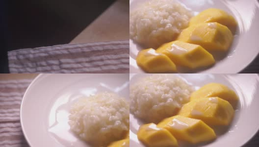 镜头对准泰国芒果和糯米，这是泰国风味的甜点。高清在线视频素材下载