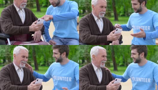微笑的男性志愿者向残障老人讲解如何使用手机app，关爱老人高清在线视频素材下载