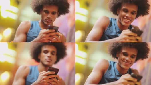 年轻英俊的非洲黑人男子手持手机科技设备微笑高清在线视频素材下载
