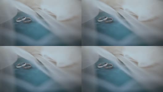 结婚戒指放在沙发椅上盖着面纱高清在线视频素材下载