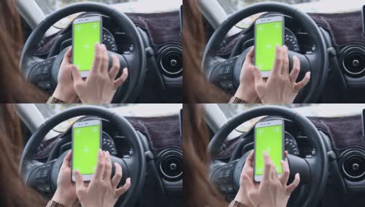 女人在路上开车并使用绿屏智能手机高清在线视频素材下载