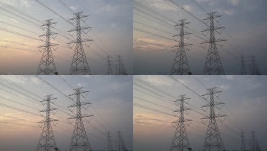 日落时分高压电塔、塔架和高压电力线的时间流逝。高清在线视频素材下载