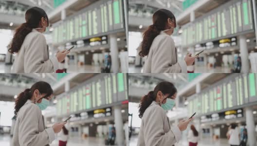 亚洲妇女戴口罩以保护冠状病毒，并在机场站在飞机上检查航班高清在线视频素材下载