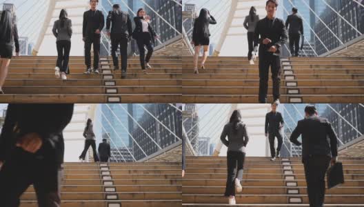 慢动作镜头。一群西装革履的亚洲商务人士正忙着走在去往办公室的楼梯上。高清在线视频素材下载