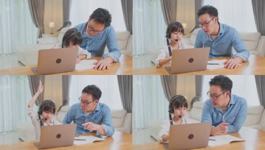 由于冠状病毒大流行，亚洲小女孩通过数字远程互联网会议向学校老师学习在线课程。孩子看着电脑，在爸爸的帮助下写纸条高清在线视频素材下载