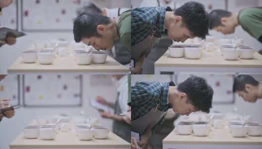 3名亚洲华裔男咖啡师品酒师表演杯咖啡，品尝杯咖啡后在剪贴板上写下高清在线视频素材下载