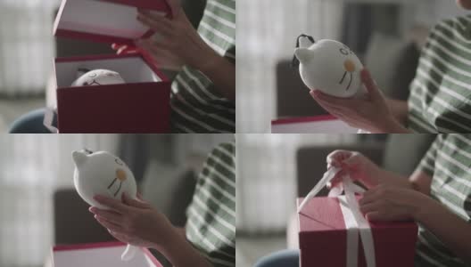 快乐的亚洲女人在家里打开礼品盒高清在线视频素材下载