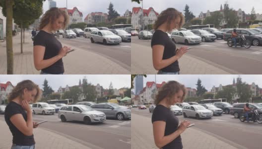 在城市里使用移动电话。一个女人正在寻找一辆免费的汽车旅行。高清在线视频素材下载