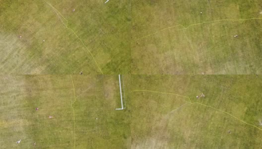 从上到下的鸟瞰图，足球场表面覆盖着绿色的草和洒水器喷洒水。高清在线视频素材下载