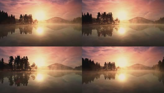鸟瞰图的山湖在雾蒙蒙的日出，4k视频高清在线视频素材下载