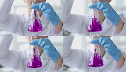 科学家滴粉色液体到化学烧瓶4k电影高清在线视频素材下载