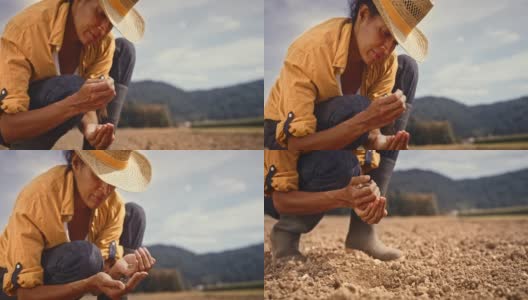 女农民在阳光地里检查土壤结构高清在线视频素材下载