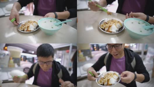 亚洲游客在香港当地餐厅吃米粉卷和粥。高清在线视频素材下载