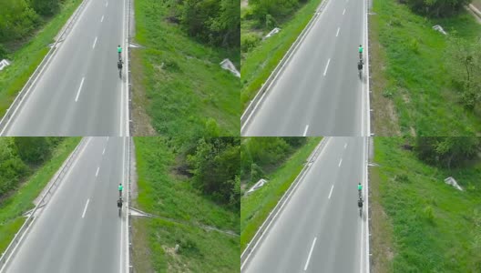 两个骑自行车的人在高速公路上。鸟瞰图高清在线视频素材下载