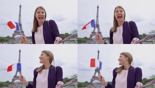 在埃菲尔铁塔附近举着法国国旗自拍的女人。微笑的女游客在欧洲旅行高清在线视频素材下载