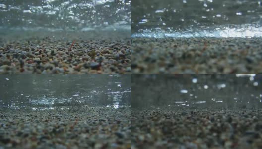 水下拍摄。沙子，沙滩卵石和海浪特写。继续教育高清在线视频素材下载