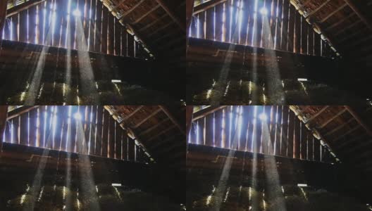 在旧谷仓的阁楼上，灰尘在阳光的照射下缓慢移动高清在线视频素材下载