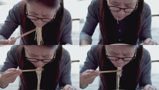 吃面条的亚洲女人。高清在线视频素材下载