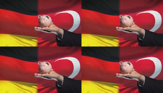 德国在土耳其投资，手把钱放在存钱罐里的旗帜背景高清在线视频素材下载