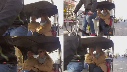 一对情侣坐在自行车出租车里，互相聊天高清在线视频素材下载