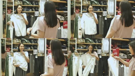 亚洲妇女在商店试穿衣服高清在线视频素材下载