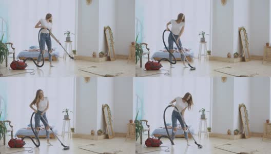 年轻女子有乐趣打扫房子与吸尘器跳舞和唱歌在家里高清在线视频素材下载