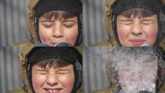 小男孩挤着眼睛，把手掌上的雪吹走高清在线视频素材下载