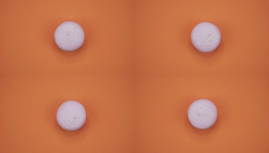 旋转:一个彩色的蛋白杏仁在橙色的背景上旋转高清在线视频素材下载