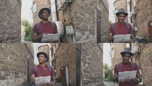 斯坦尼康镜头的非洲裔美国游客走和看纸城市地图寻找方向到著名的地方高清在线视频素材下载
