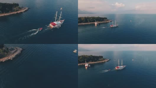 鸟瞰图的一艘大船拖着一艘船在海湾与深蓝色的水在日落，在4K超高清拍摄高清在线视频素材下载