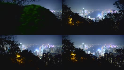 香港夜晚的天际线和美丽的城市灯光与树木和自然-稳定的框架运动镜头高清在线视频素材下载