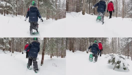 在暴风雪后的冬天，母亲和儿子在户外穿雪鞋高清在线视频素材下载