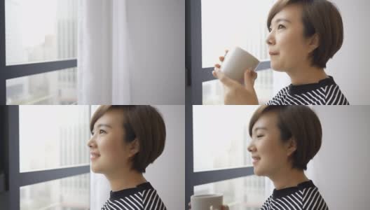 在窗边喝咖啡的漂亮女人高清在线视频素材下载