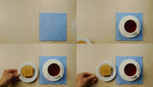 一杯茶，一碟饼干，一碗果酱和牛奶壶放在明亮的桌子上。高清在线视频素材下载