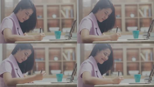 亚洲商业女性作为自由职业者使用电脑笔记本电脑从家里工作高清在线视频素材下载
