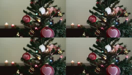 圣诞树和心形的球，并在家里插上蜡烛高清在线视频素材下载