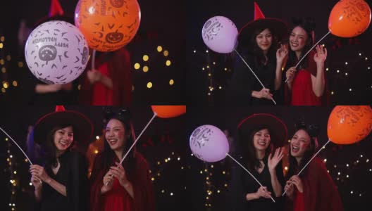 万圣节前夕穿着女巫服装并拿着气球的亚洲妇女。高清在线视频素材下载