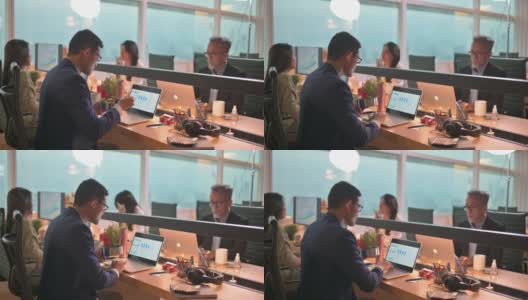亚洲华裔年轻商人在办公室里工作，在他的工作场所用笔记本电脑做他的报告高清在线视频素材下载
