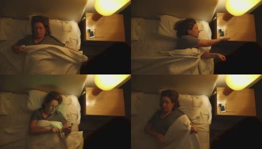 老妇人躺在床上盖着毯子准备睡觉，老妇人拿起被子，俯视图高清在线视频素材下载