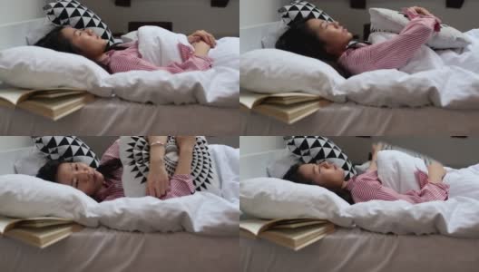 年轻的中国女人躺在床上高清在线视频素材下载