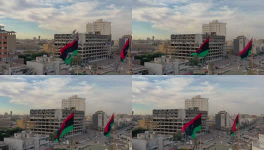 利比亚国旗飘扬在利比亚首都的黎波里上空。的黎波里的轮廓视图。高清在线视频素材下载