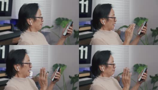 老奶奶在家用智能手机与孙辈视频通话。高清在线视频素材下载