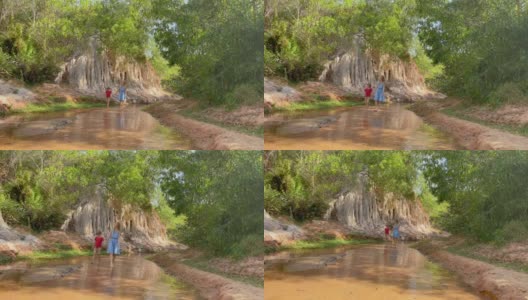 Slowmotion。在越南南部的梅尼村，一个家庭沿着沙漠边界的红色峡谷或仙女溪散步。用手机拍摄高清在线视频素材下载