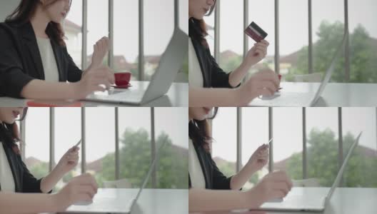 一位亚洲女商人正在用她的信用卡和笔记本电脑进行网上银行业务。技术和商业的概念高清在线视频素材下载